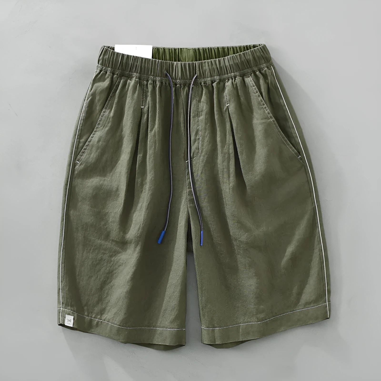 Men's green linen straight shorts with drawstring waist on hanger