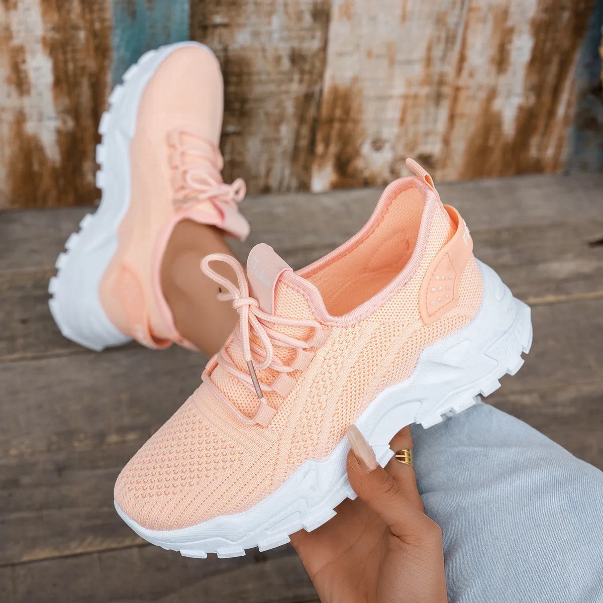 Women's Flyknit mesh casual sports shoes in multiple colours, showing lace-up design and flat sole.