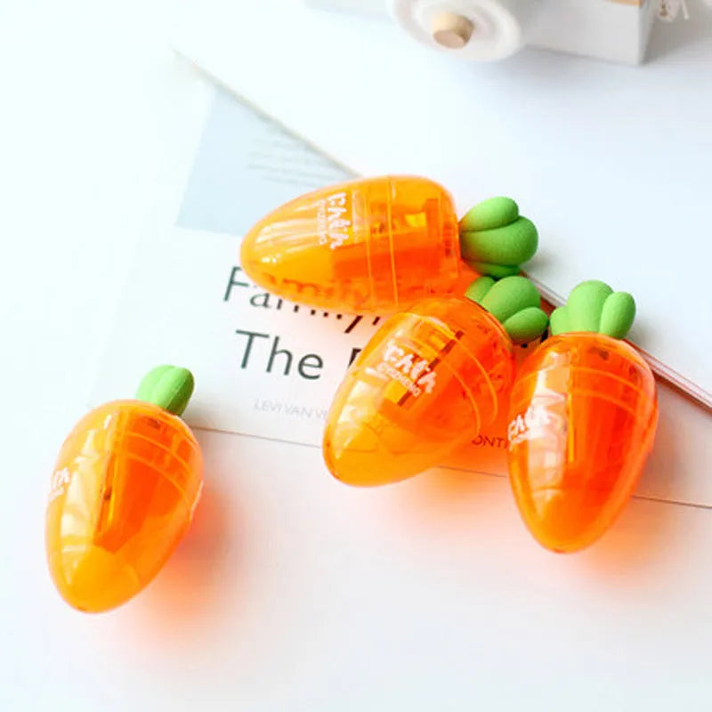 Orange carrot-shaped plastic pencil sharpener with green top, 7cm total length