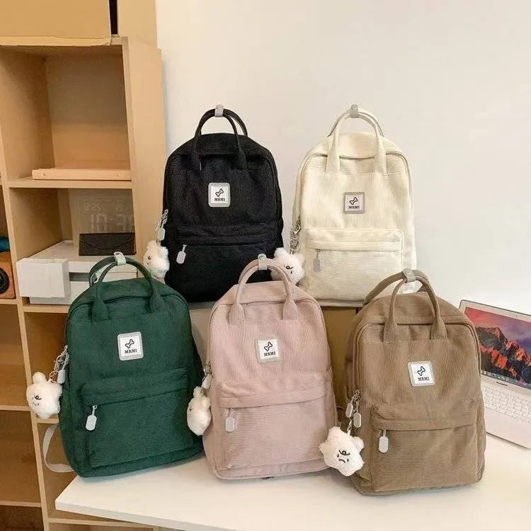 Retro hand-carrying backpack in light pink with breathable fabric, document pocket, and sewing line details for school use.