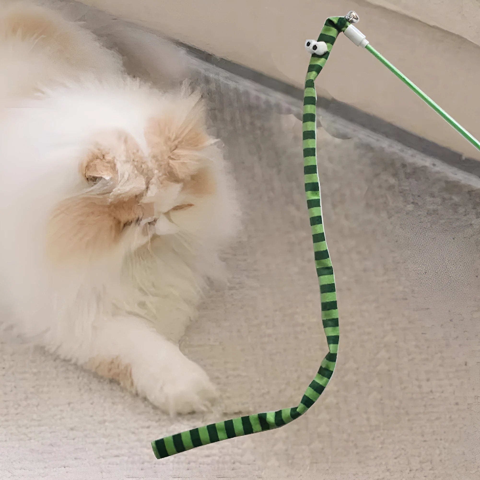 Cat wand toy with colourful plush strip and bell on a polycarbonate pole.