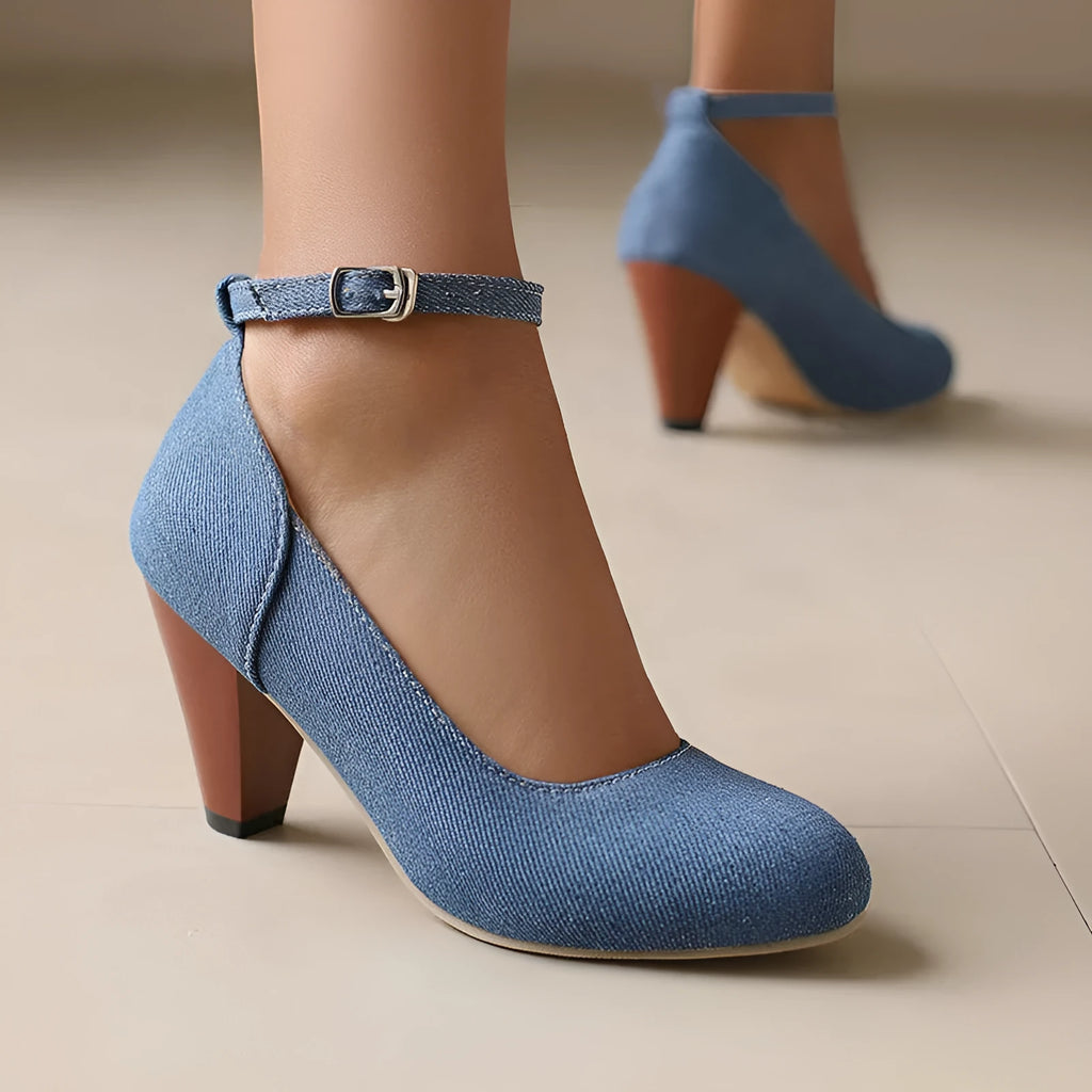 Women's blue denim platform high heels with an ankle buckle and a thick rubber sole.