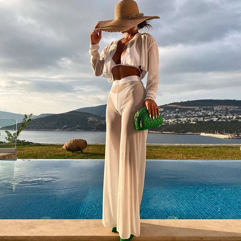 White women's swimsuit four-piece set showing backless top and high-waisted trousers
