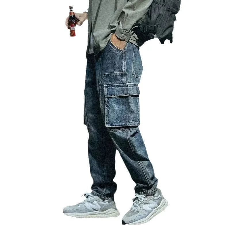 Man wearing blue loose straight-leg retro jeans with a zip fly, showcasing the casual fit.