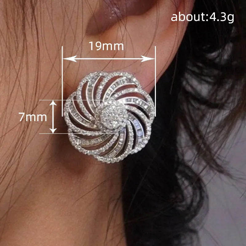 Copper geometric line flower design earrings with inlaid zircon in white gold colour on a neutral background