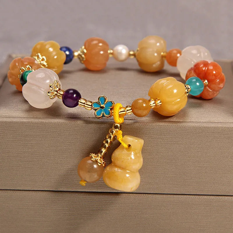 Khaki women's bracelet with yellow agate crystals threaded on a gold silk cord.
