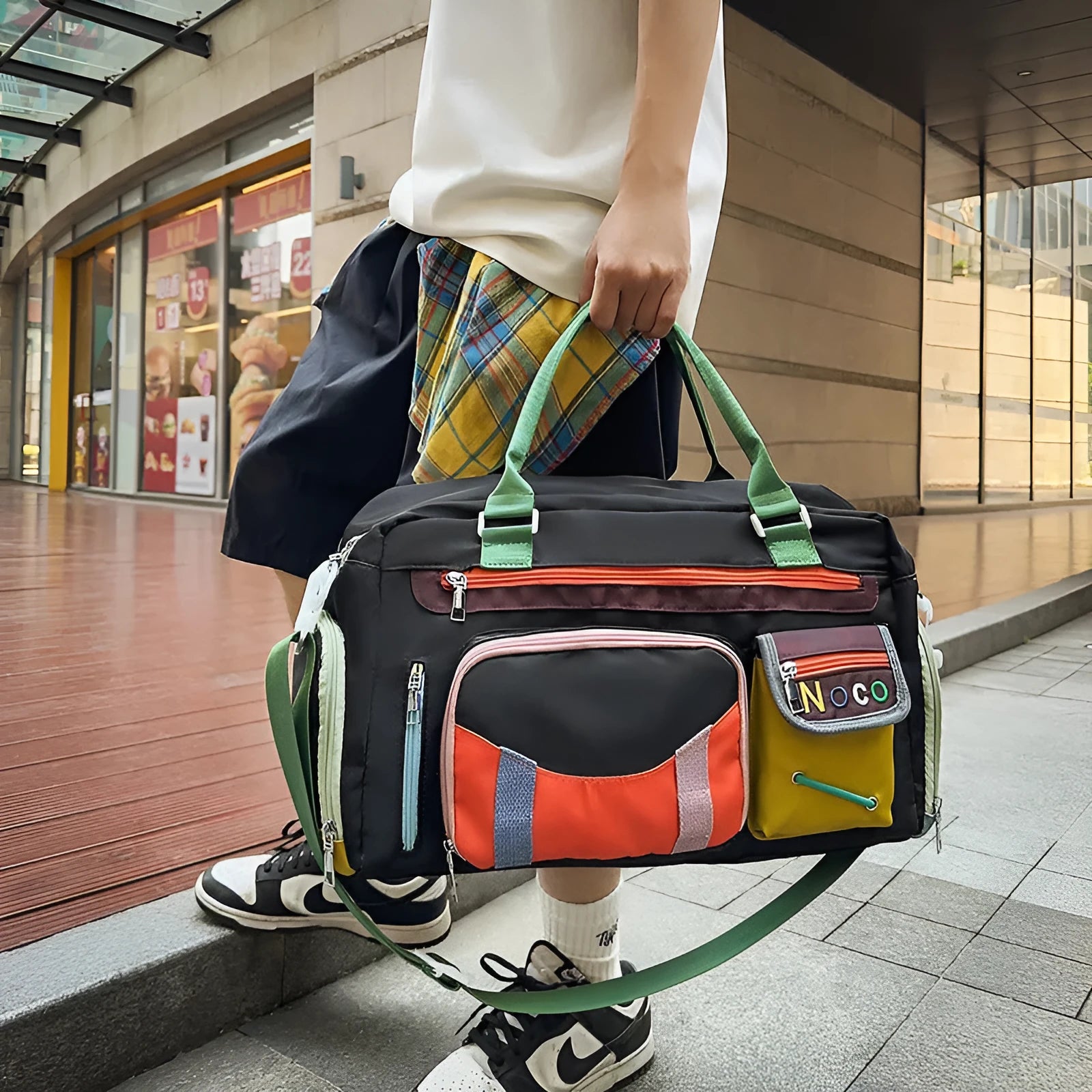 Large black sports messenger bag with shoulder strap showing spacious interior and Oxford cloth construction