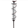 Traditional cast iron bird design outdoor rain gauge with glass measurement chamber showing 1-20 scale