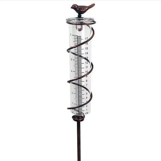 Traditional cast iron bird design outdoor rain gauge with glass measurement chamber showing 1-20 scale