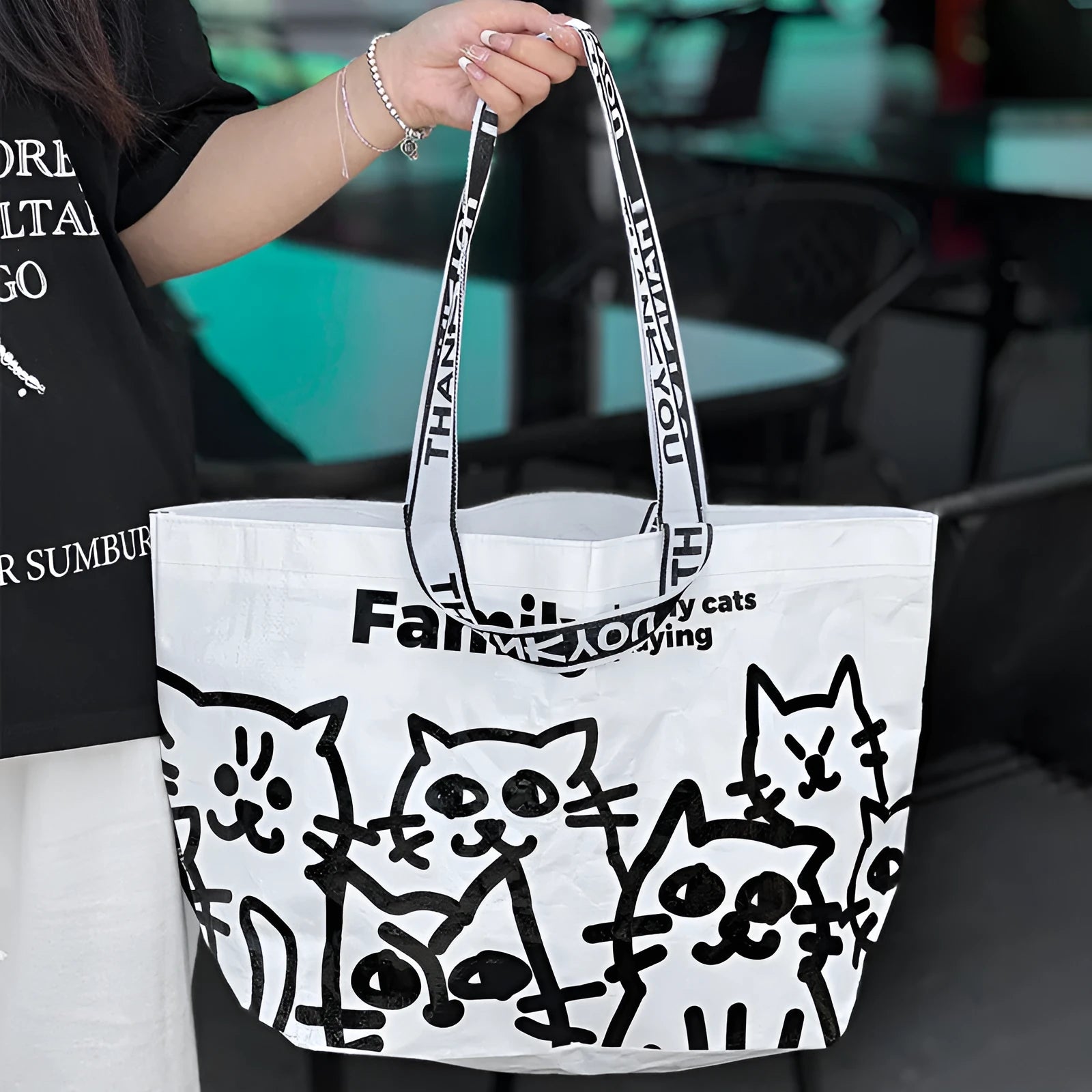 Waterproof woven handbag in PP fabric with colour-printed snakeskin pattern.