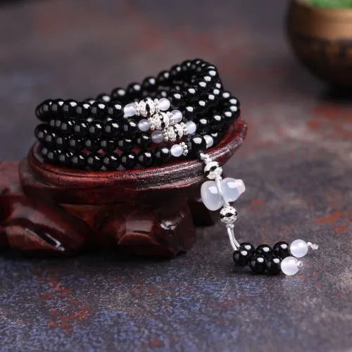 Black agate 108 beads bracelet with geometric shapes and numeric markers on unisex wrist
