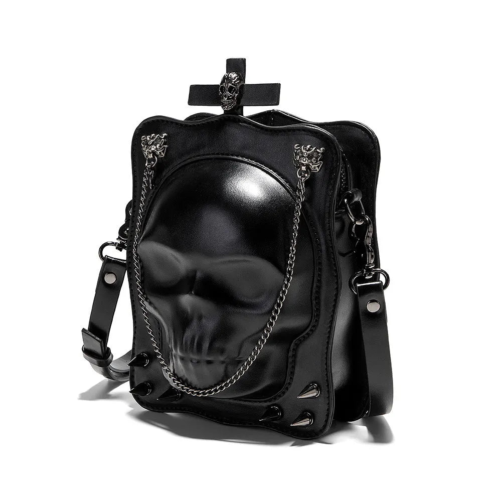 Black mini square crossbody bag with embossed skull design and metal chain strap