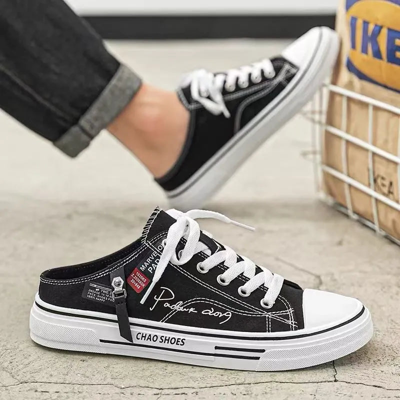 Men's black canvas slip-on casual shoes with round toe and PVC sole.