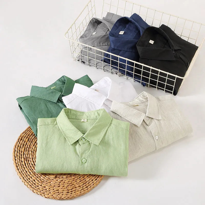 Loose long sleeve linen shirt in a cardigan style on a hanger, shown in light sapphire blue colour.