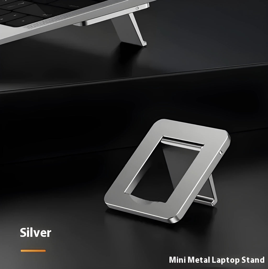 Small foldable aluminium laptop stand in silver colour next to laptop for size comparison