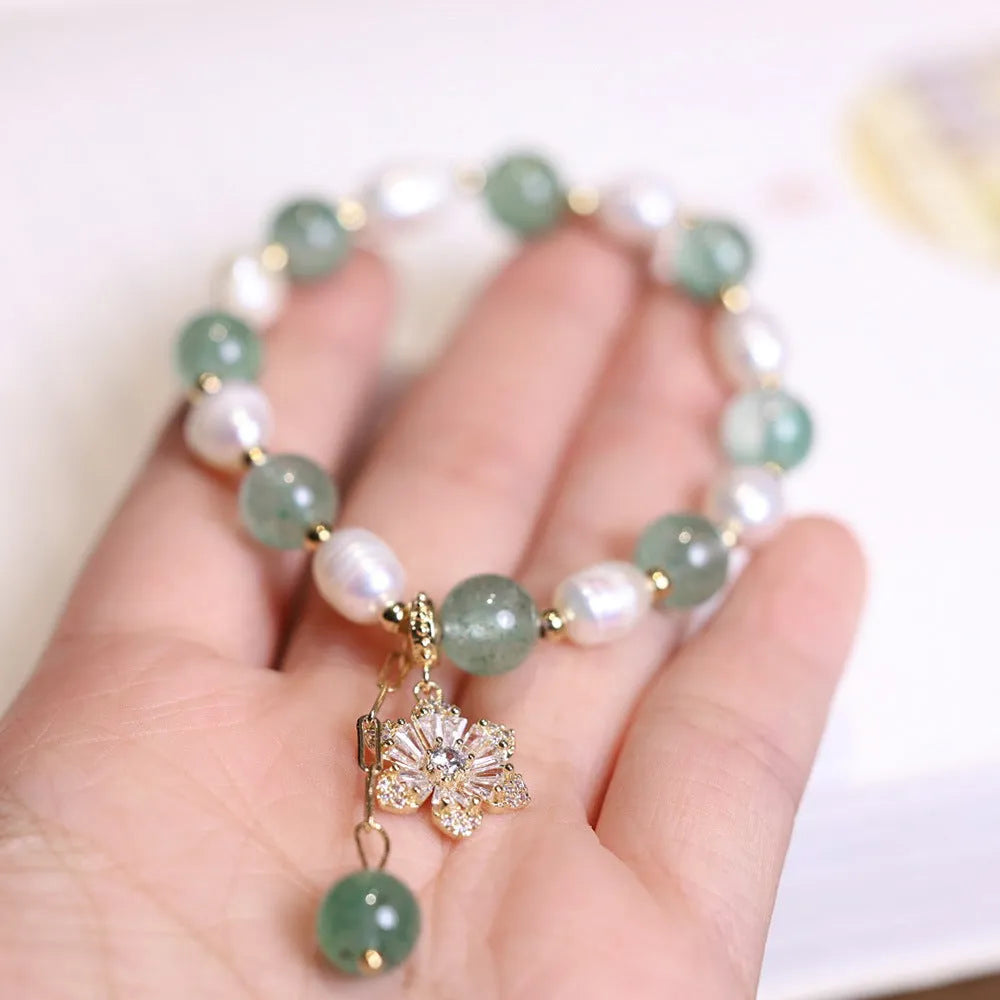 Green freshwater pearl bracelet with Chinese knot design and strawberry pearl hanging detail
