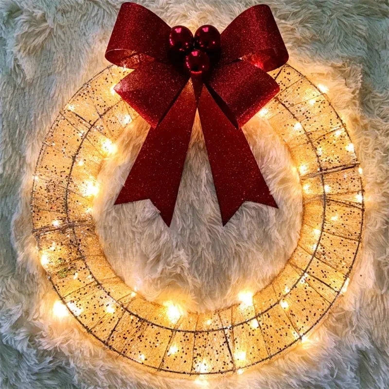 50cm gold green tinsel Christmas garland with LED lights and big bowknot on a wooden door