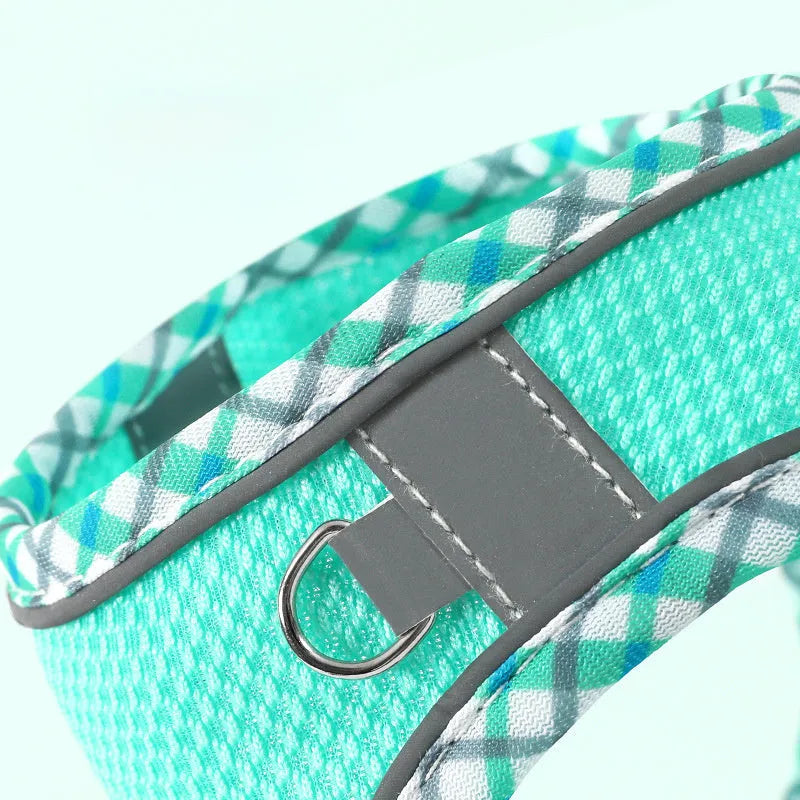 Step-in no-pull dog harness with attached leash, made from breathable mesh with reflective strips and a plastic quick-release buckle.