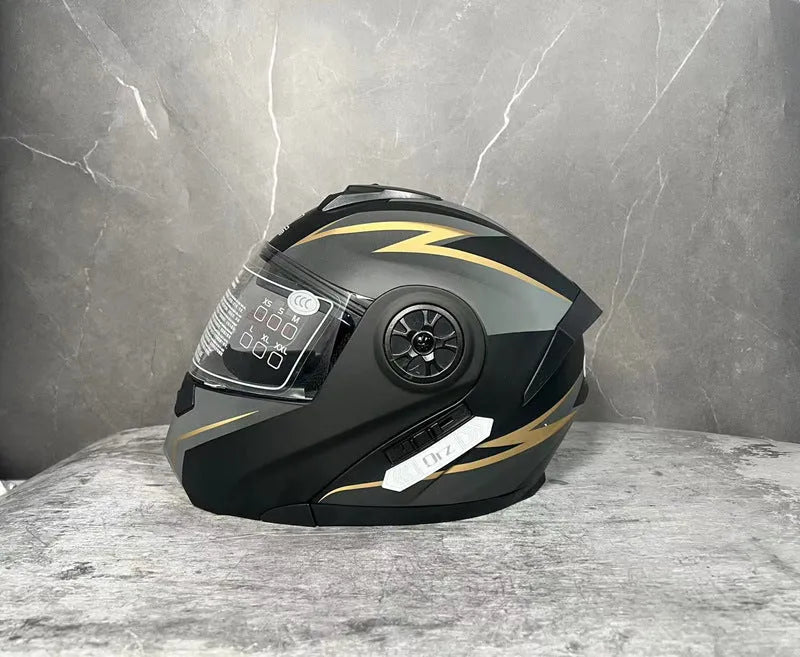 Matte black full face motorcycle helmet with integrated battery visor on a stand