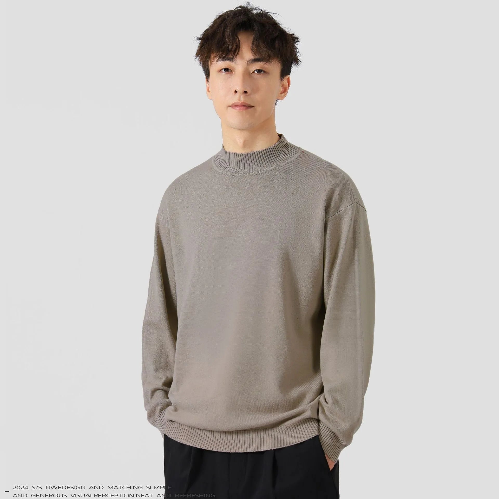 A man's loose-fitting solid colour long sleeve sweater in a chemical fibre viscose blend.