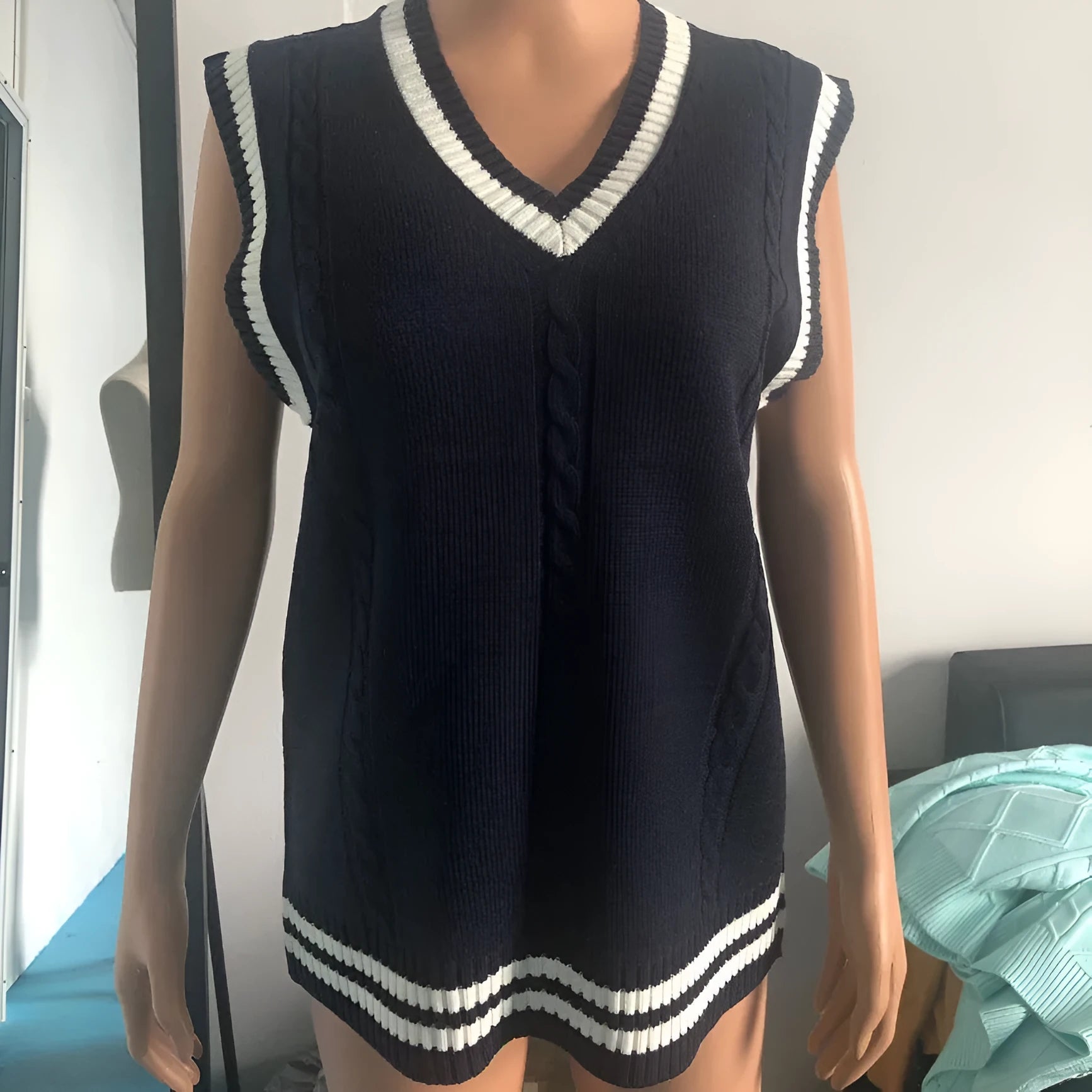 Women's slim fit acrylic V-neck waistcoat sweater with striped stitching in various colours.