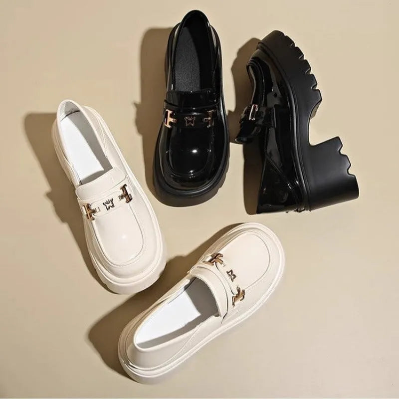 Black women's slip-on shoes with a skull pattern, chunky square heel, and round toe on a white background.