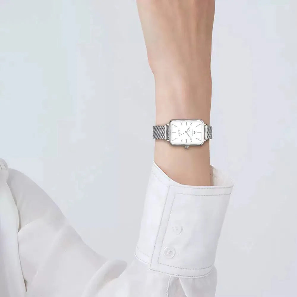 Women's rose gold or silver waterproof watch with woven steel strap and analogue dial.