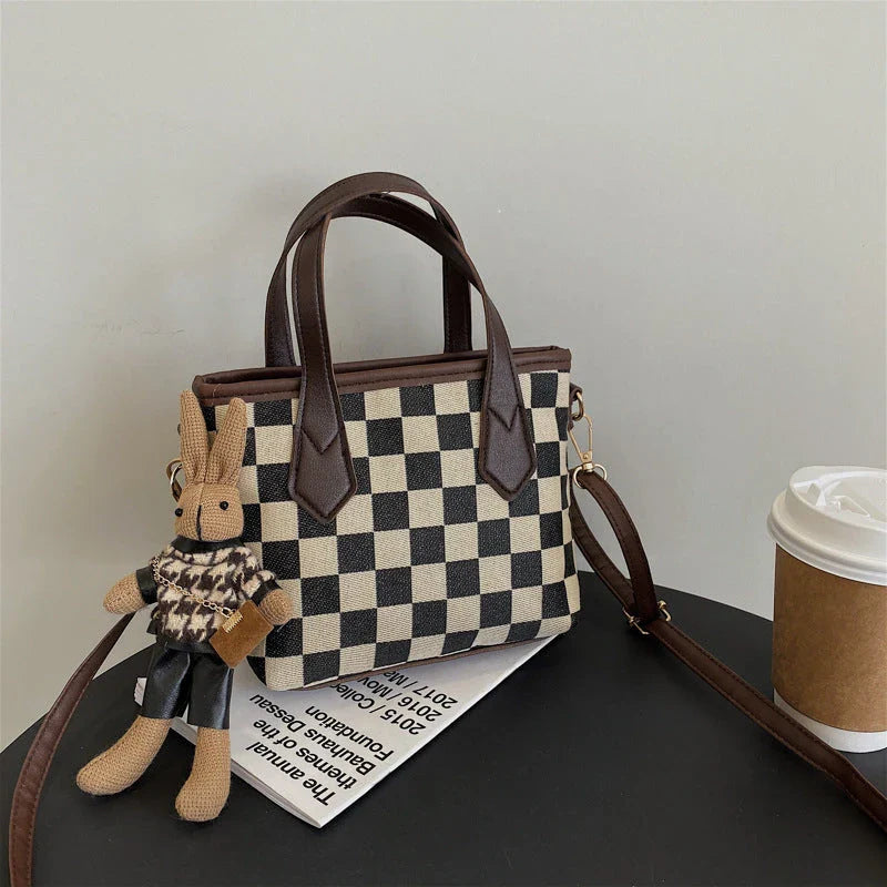 Stylish houndstooth shoulder bags in various colors, featuring a spacious square shape, adjustable strap, and classic checkerboard pattern.