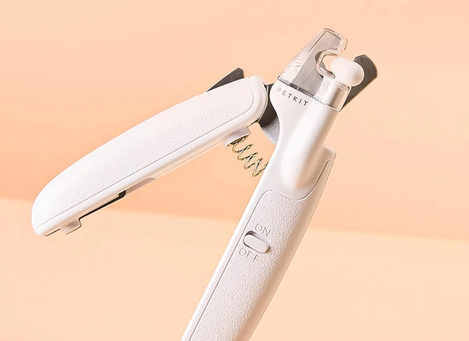 White LED pet nail clippers with a transparent anti-splash guard and an integrated nail file on a grey background.