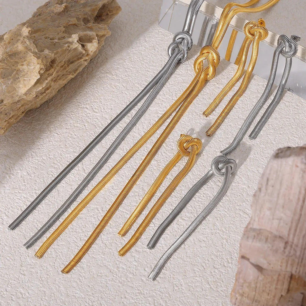 Gold knotted tassel snake chain long necklace with matching electroplated earrings on titanium steel