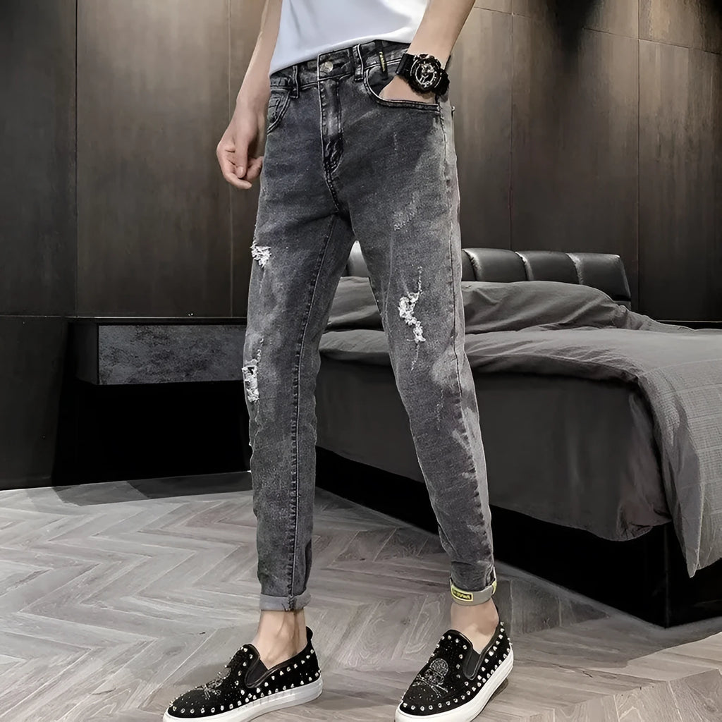 Men's high waist blue jeans with a five-pocket design and button fly on a mannequin.