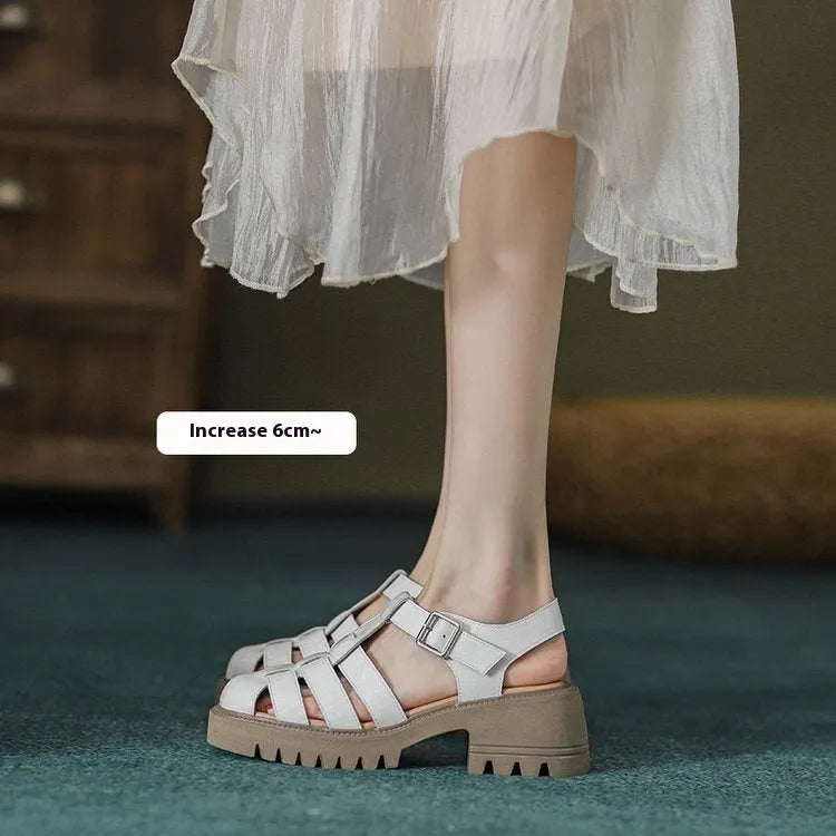Women's black retro platform sandals with closed toe, hollow out holes, and a silver buckle closure on a chunky rubber heel.