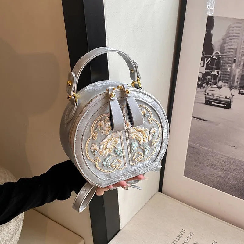Soft PU Chinese embroidery messenger bag in horizontal square shape with adjustable shoulder strap.