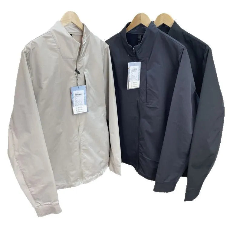 Man wearing a beige stand collar polyester casual jacket with long sleeves and a straight hem.