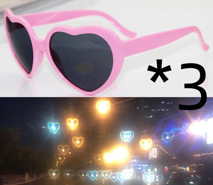 Heart-shaped glow-in-the-dark sunglasses in various vibrant colors, featuring a durable plastic frame and resin lenses for reliable UV protection.