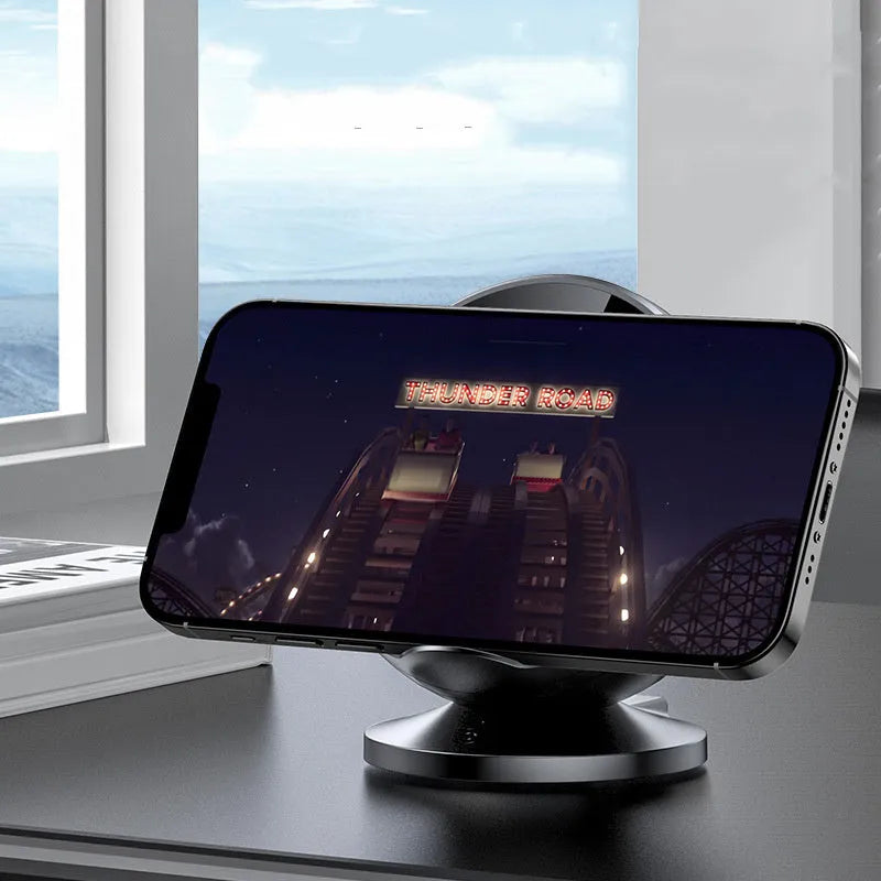 XC-11 black wireless charging phone holder with integrated Bluetooth speaker on a desk.