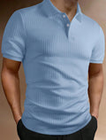 Man wearing a striped loose-fit polo shirt with an asymmetric design in light blue.