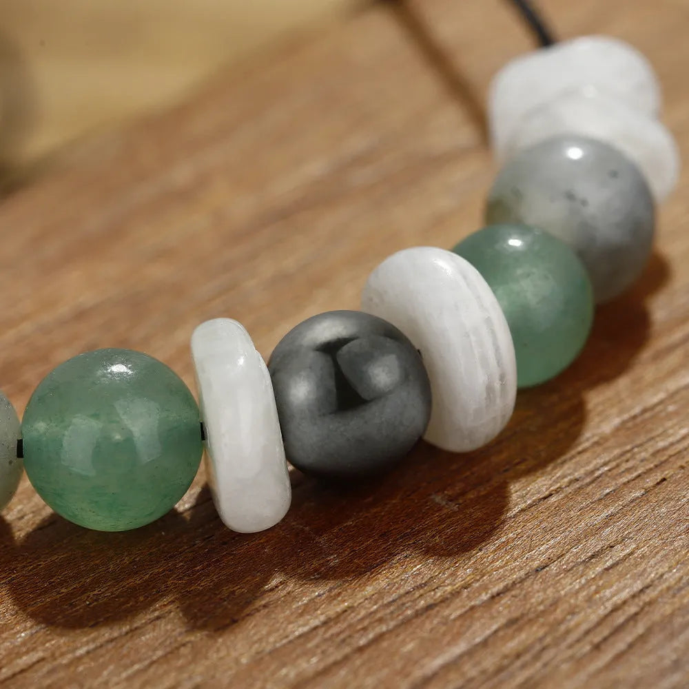 A handcrafted women's bracelet with geometric stone beads in colour 3906 on a wrist.