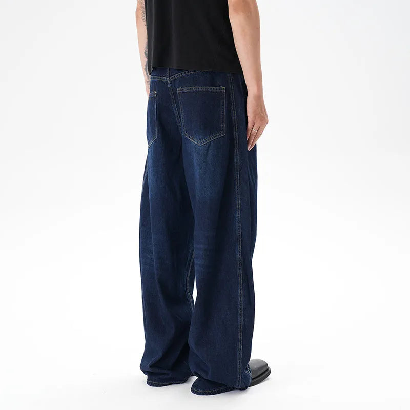 Dark blue wide leg distressed jeans on a hanger showing washed denim fabric and machete cut.