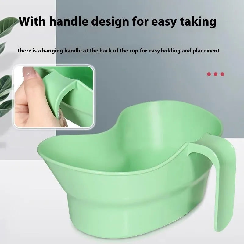 Green plastic gargle cup with spout for bedridden patient oral hygiene assistance