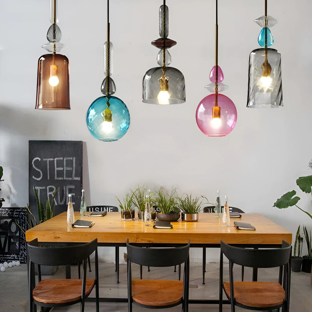 Glass droplet chandelier with adjustable height, hanging above a bar counter.
