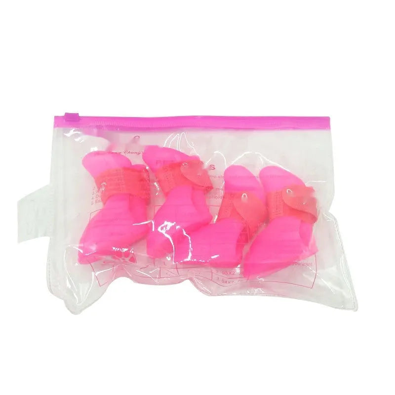 Four rubber pet rain shoes in various colours with anti-slip soles for dog paw protection