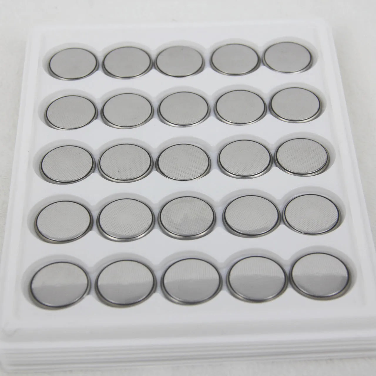 Pack of 3V button cell batteries showing CR2032, CR2025, and CR2016 sizes for small electronics.