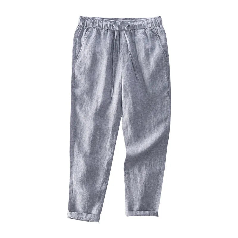 Men's straight leg linen trousers in dark grey, shown laid flat.