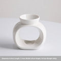 White glazed porcelain Nordic style aromatherapy stove ornament on a table.