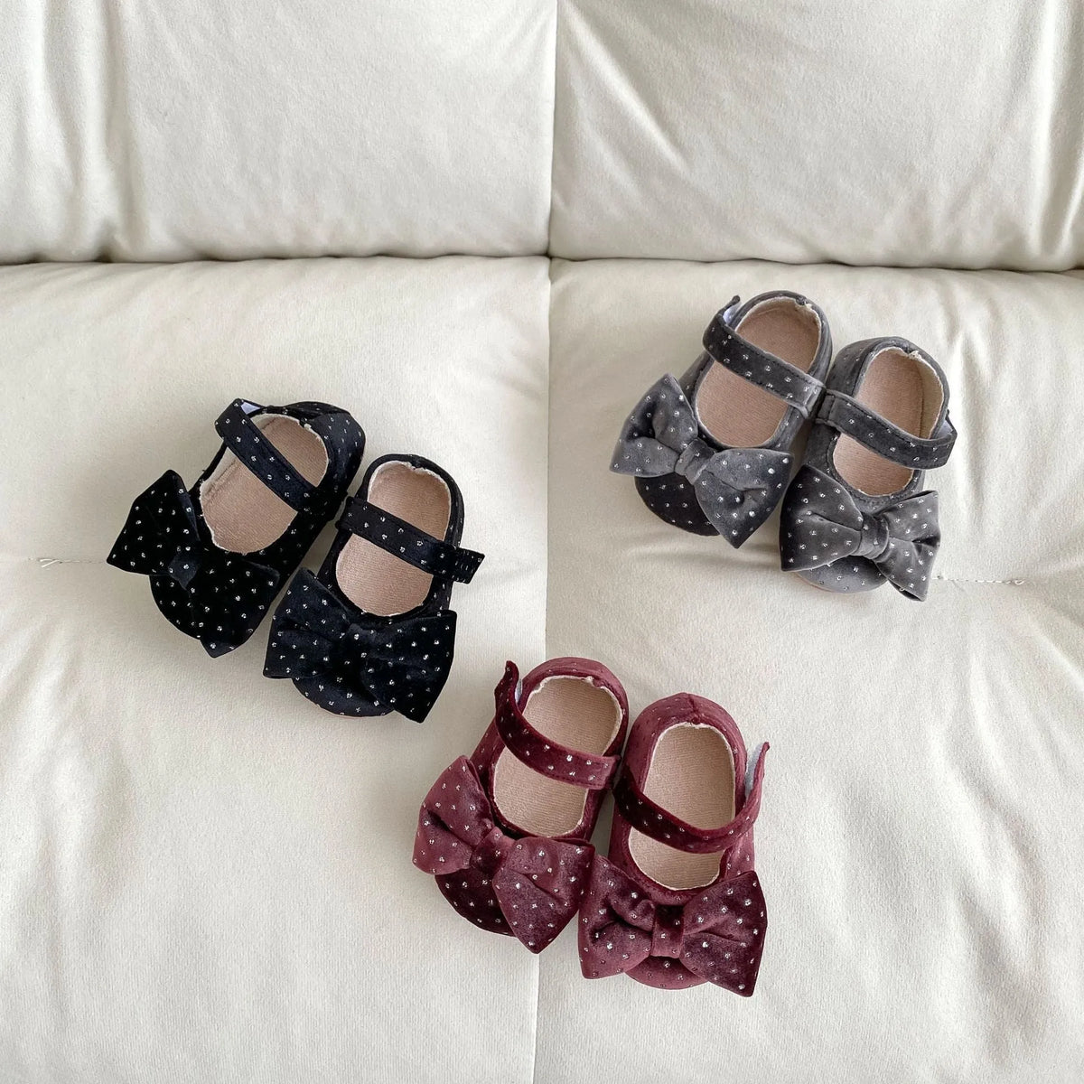 Baby girl toddler shoes with big bow and dots pattern in black on white background