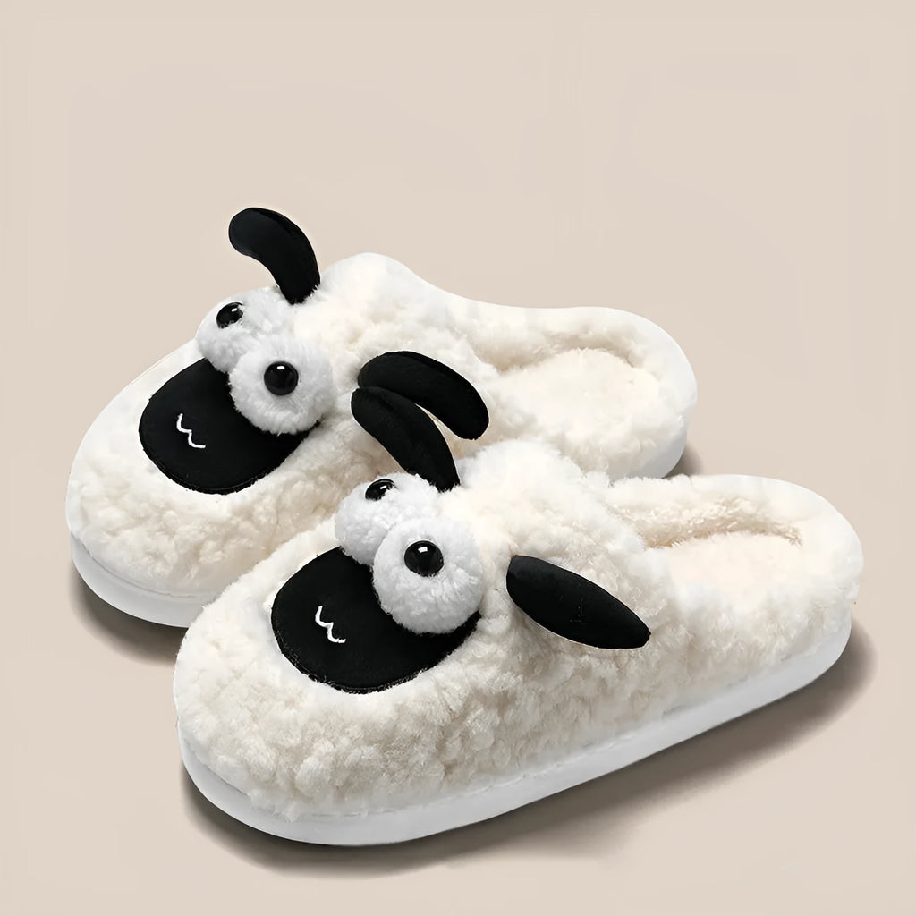 Brown unisex slip-on slippers with suede upper and light sole on a wooden floor.