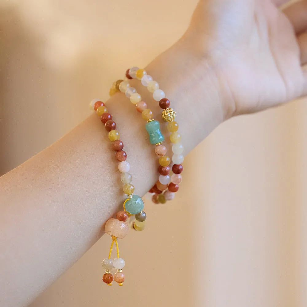 Women's Jinsi Jade bracelet with three pumpkin beads and tassel decoration on wrist