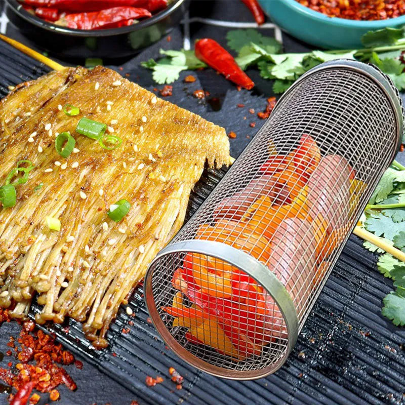 Round rolling metal barbecue grill basket with mesh sides and a handling hook, shown with BBQ gloves.