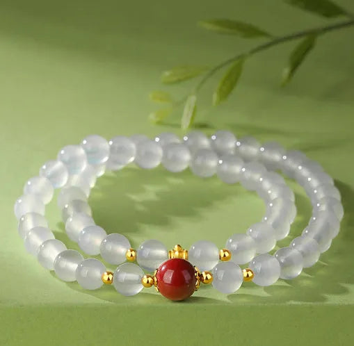 White agate women's bracelet with 6mm beads, geometric double-layer design and a jequirity bean cinnabar accent.
